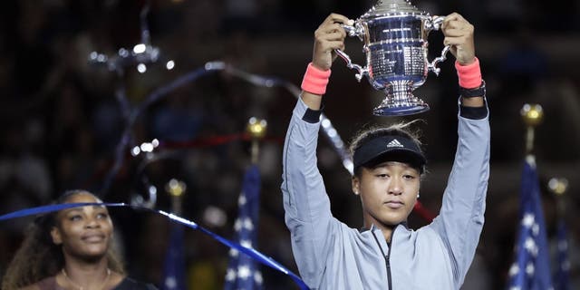 Naomi Osaka, of Japan, holds the trophy after defeating Serena Williams in the women's final of the U.S. Open tennis tournament, Saturday, Sept. 8, 2018, in New York. (Associated Press)