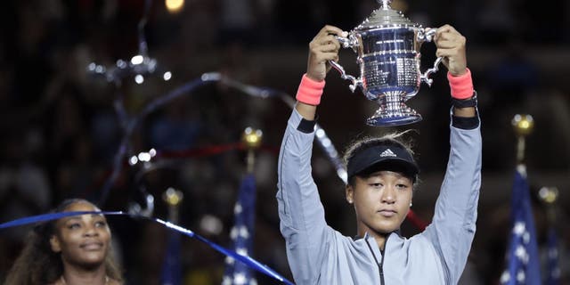 Naomi Osaka, of Japan, holds the trophy after defeating Serena Williams in the women's final of the U.S. Open tennis tournament, Saturday, Sept. 8, 2018, in New York. (Associated Press)