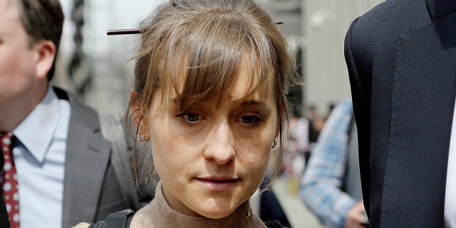 FILE- In this April 8, 2019 file photo, actress Allison Mack leaves Brooklyn federal court in New York after pleading guilty to racketeering charges in a case involving a cult-like group based in upstate New York called NXIVM. Some speculate that Mack may take the witness stand to testify against Keith Raniere, the group's one-time leader who is facing federal charges of forming a secret society within his organization that forced women to have sex with him. (AP Photo/Mark Lennihan, File)