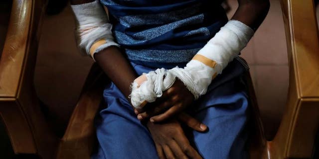 An injured member of Zion Church, which was bombed on Easter Sunday, cries as she prays at a community hall on May 5, 2019.