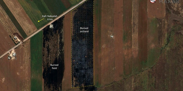 This satellite image provided by Maxar Technologies on Tuesday, May 28, 2019 shows significant damage to fields and orchards south of Kfar Nabudah, Syria, on May 26 as a result of a government offensive against the last rebel stronghold in the country.