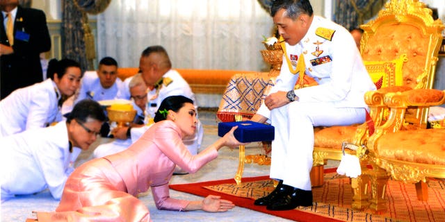 In this photo released by Bureau of the Royal Household ,Thailand's King Maha Vajiralongkorn Bodindradebayavarangkun, right, presents a gift to Queen Suthida Vajiralongkorn Na Ayudhya at Ampornsan Throne Hall in Bangkok, Thailand, Wednesday, May 1, 2019.(Bureau of the Royal Household via AP)