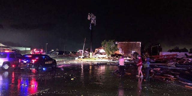People look over heavy tornado damage in El Reno, Okla., on Saturday night. (FOX 25, Oklahoma City)