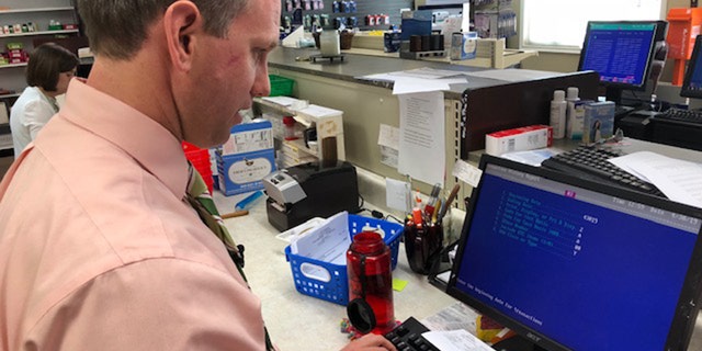 Cole Sandlin works to fill a prescription for a customer in Hamilton, Alabama where high speed internet is recently emergeing. (Fox News/Charles Watson)