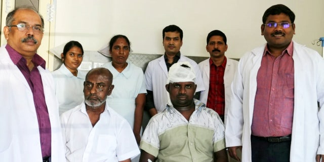 Sakthivel, pictured with his surgeons, is said to be doing well.