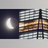 The moon rises behind One World Trade Center before sunrise in New York City, April 29, 2019.