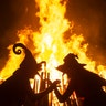 Women dressed as witches dance in front of the fire during the Walpurgis night in Erfurt, Germany, April 30, 2019. 