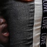 A Haitian migrant youth cries next to his father as they wait in line to solve their migratory situation at an immigration center in Tapachula, Chiapas state, Mexico, May 28, 2019. 