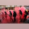 Smoke from flares engulfs riot police officers as they walk along with marching right-wing supporters following scuffles with left-wing protesters in the city of Brno, Czech Republic, May 1, 2019. 