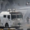 A Bolivarian National Guard water canon sprays opponents of Venezuela's President Nicolas Maduro during an attempted military uprising and anti-government protests in Caracas, Venezuela, April 30, 2019.