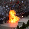 A petrol bomb explodes after being thrown toward a police line blocking protesters taking part in an anti-government rally in Tirana, May 11, 2019. 