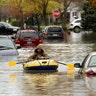 A Hanover Street resident surveys the damage along Currier Street following flooding in Dearborn Heights, Michigan, May 1, 2019. 