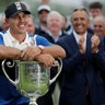 Brooks Koepka poses with the Wanamaker Trophy after winning the PGA Championship golf tournament at Bethpage Black in Farmingdale, New York, May 19, 2019.