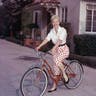 Doris Day poses on a red Schwinn bicycle in the late 1950s.