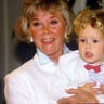 Doris Day poses with her grandson, Ryan Melcher (the son of her only child Terry Melcher) at a press conference at the hotel she owns in Carmel, Calif., in July 1985.