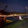 Downed power lines stretch into a street in Jefferson City. (AP Photo/David A. Lieb)