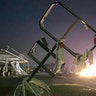 A destroyed sign for a car wash is seen in tornado-hit Jefferson City, Mo., Thursday. The heavily damaged gas station is at the background. (AP Photo/David A. Lieb)