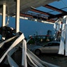 A car is trapped under the fallen metal roof of the Break Time gas station and convenience store. (AP Photo/David A. Lieb)