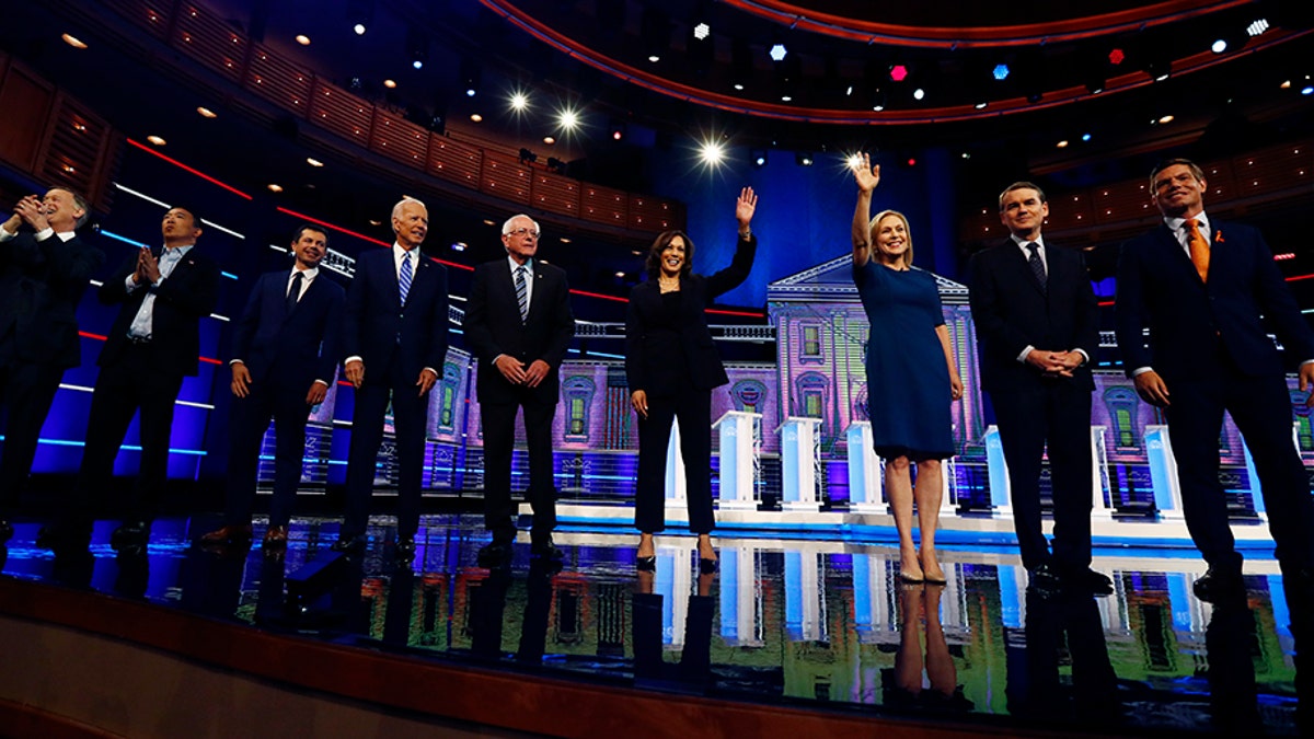 Democratic presidential candidates, from left, former Colorado Gov. John Hickenlooper, entrepreneur Andrew Yang, South Bend, Ind., Mayor Pete Buttigieg, former Vice-President Joe Biden, Sen. Bernie Sanders, I-Vt., Sen. Kamala Harris, D-Calif., Sen. Kristen Gillibrand, D-N.Y., former Colorado Sen. Michael Bennet and Rep. Eric Swalwell, D-Calif., assembled in Miami last months. (AP Photo/Brynn Anderson)