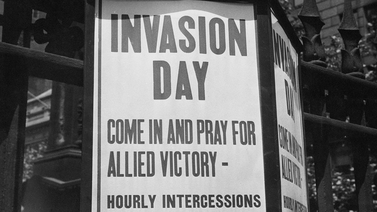 A sign is depicted saying: "Invasion Day: Come in and pray for allied victory - hourly intercessions on the hour."
