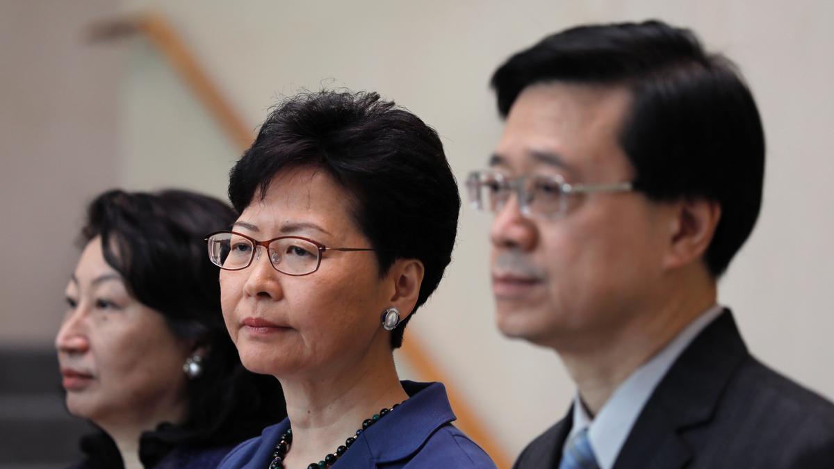 Hong Kong Secretary for Security John Lee, right, Hong Kong Chief Executive Carrie Lam, center, and Secretary of Justice Teresa Cheng listen to reporters questions during a press conference in Hong Kong on June 10, 2019.  (AP Photo/Vincent Yu)