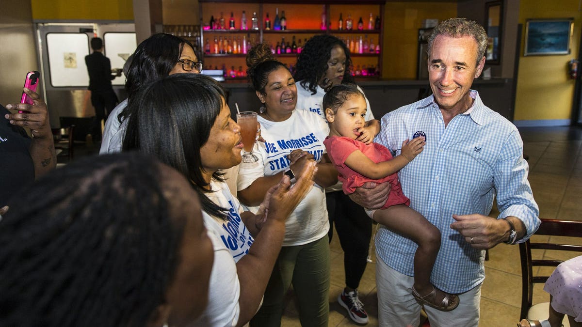 Joe Morrissey, right, with his daughter Bella, 3, celebrates his Democratic primary win in 16th District State Senate race with his supporters at the election party of Plaza Mexico in Petersburg, Va., Tuesday, June 11, 2019.