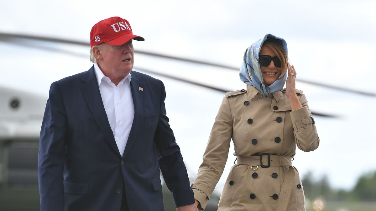 US President Donald Trump and first lady Melania Trump make their way to Air Force One at Shannon Airport in County Clare, Ireland, on June 7, 2019, for their return trip to Washington, DC. (Photo by MANDEL NGAN / AFP)