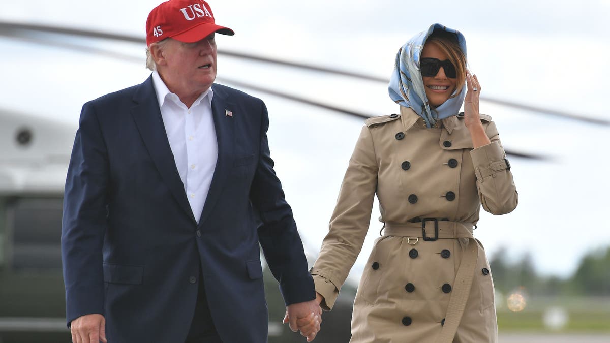US President Donald Trump and first lady Melania Trump make their way to Air Force One at Shannon Airport in County Clare, Ireland, on June 7, 2019, for their return trip to Washington, DC. (Photo by MANDEL NGAN / AFP)