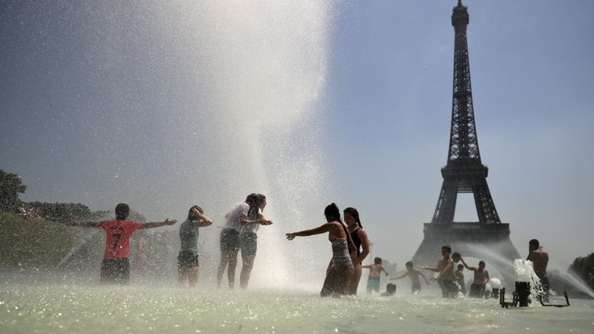 Youngsters cool off at the Trocadero public fountain in Paris, Wednesday, June 26, 2019. High temperatures are expected to go up to 39 degrees Celsius (102 Fahrenheit) in the Paris area later this week and bake much of the country, from the Pyrenees in the southwest to the German border in the northeast.