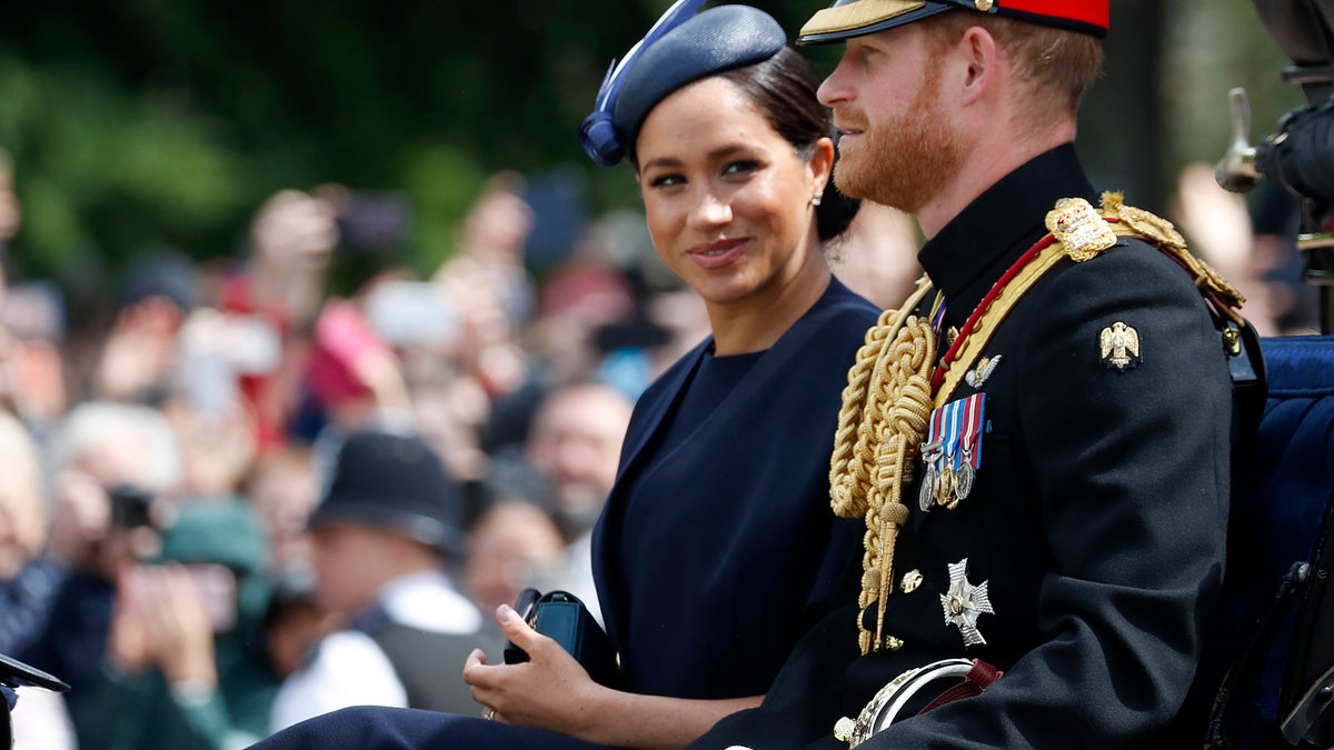 Britain's Meghan, the Duchess of Sussex and Prince Harry ride in a carriage to attend the annual Trooping the Colour Ceremony in London