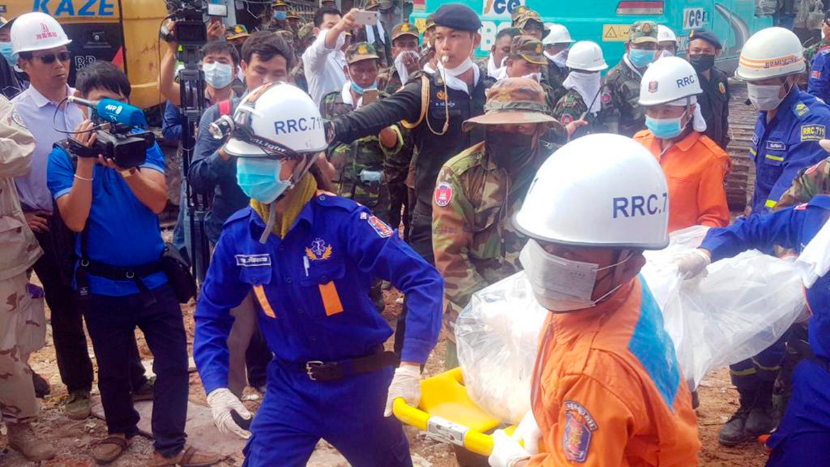 In this photo provided by Preah Sihanouk Provincial Authority, rescuers carry the body of a victim at the site of a building collapse on Monday in Preah Sihanouk province, Cambodia.