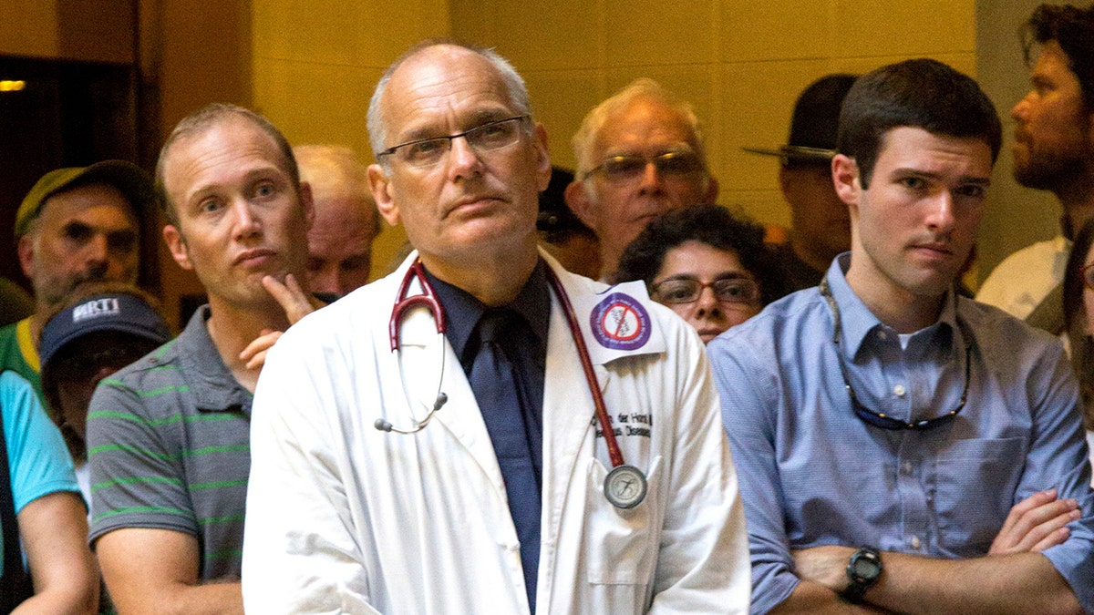 Dr. Charles van der Horst, center, was confirmed dead on Saturday after swimming down New York's Hudson River as part of a seven-stage marathon, race organizers said.