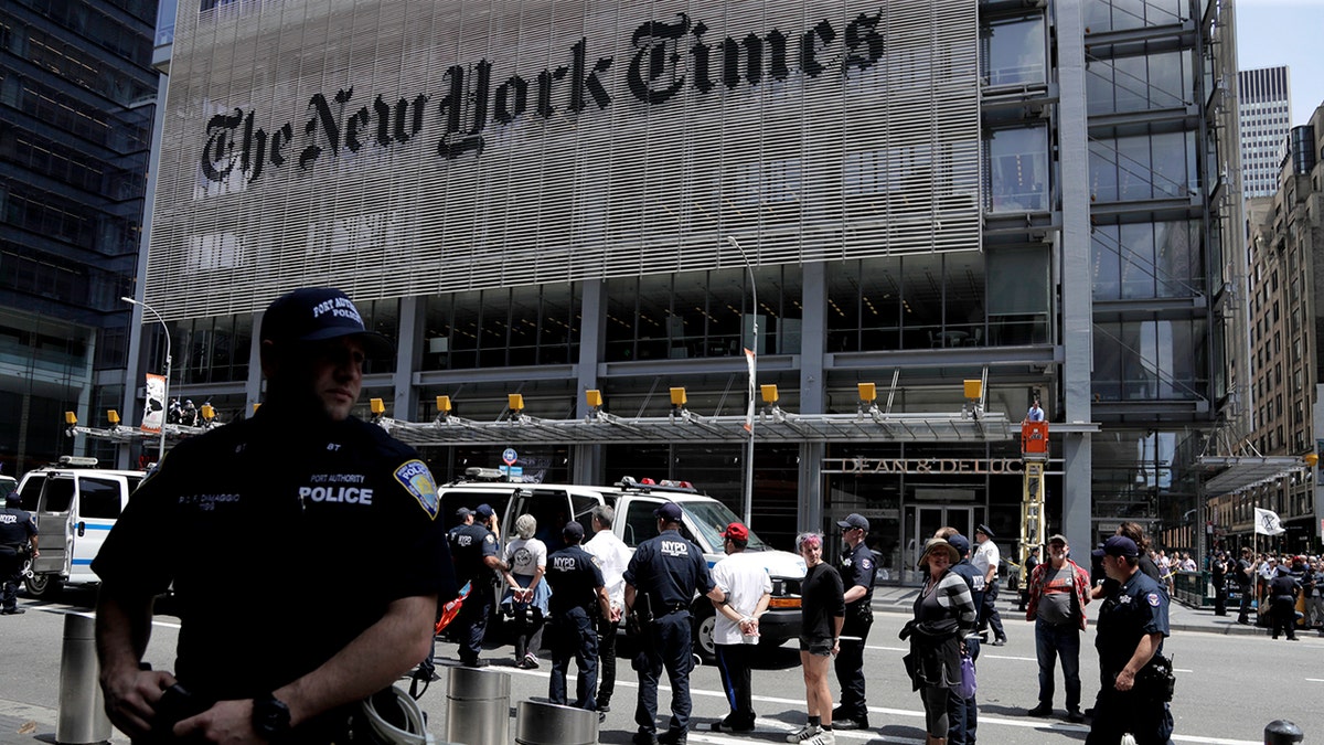 New York Police officers, pictured here taking activists into custody, arrested 70 people during a climate change rally outside of The New York Times building on Saturday.