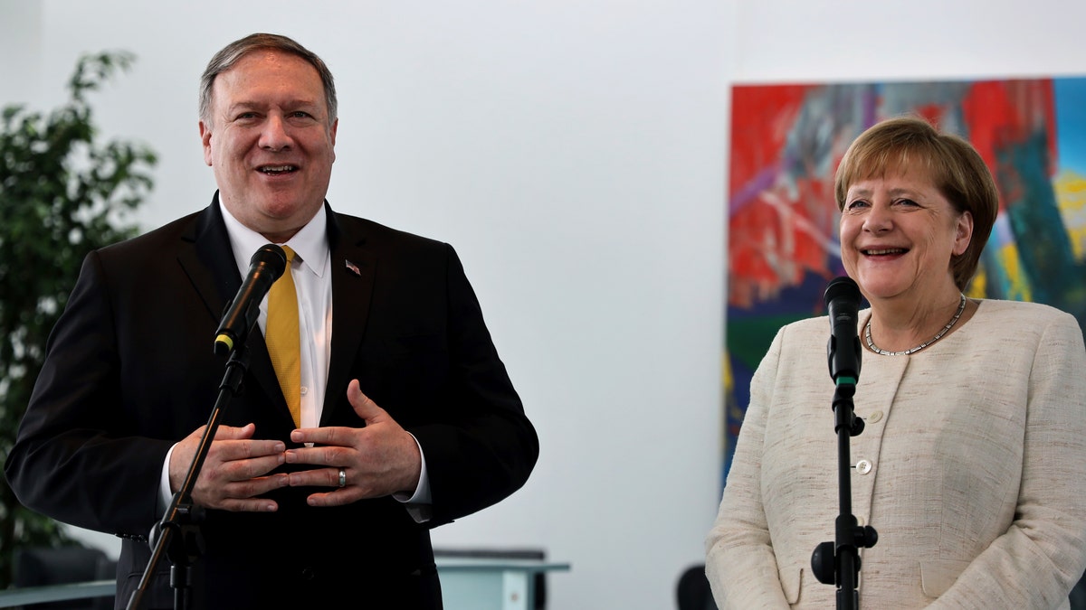 U.S. Secretary of State, Mike Pompeo, left, and German Chancellor Angela Merkel, right, address the media during a joint statement prior to a meeting at the chancellery in Berlin, Germany, Friday, May 31, 2019. (AP Photo/Michael Sohn)