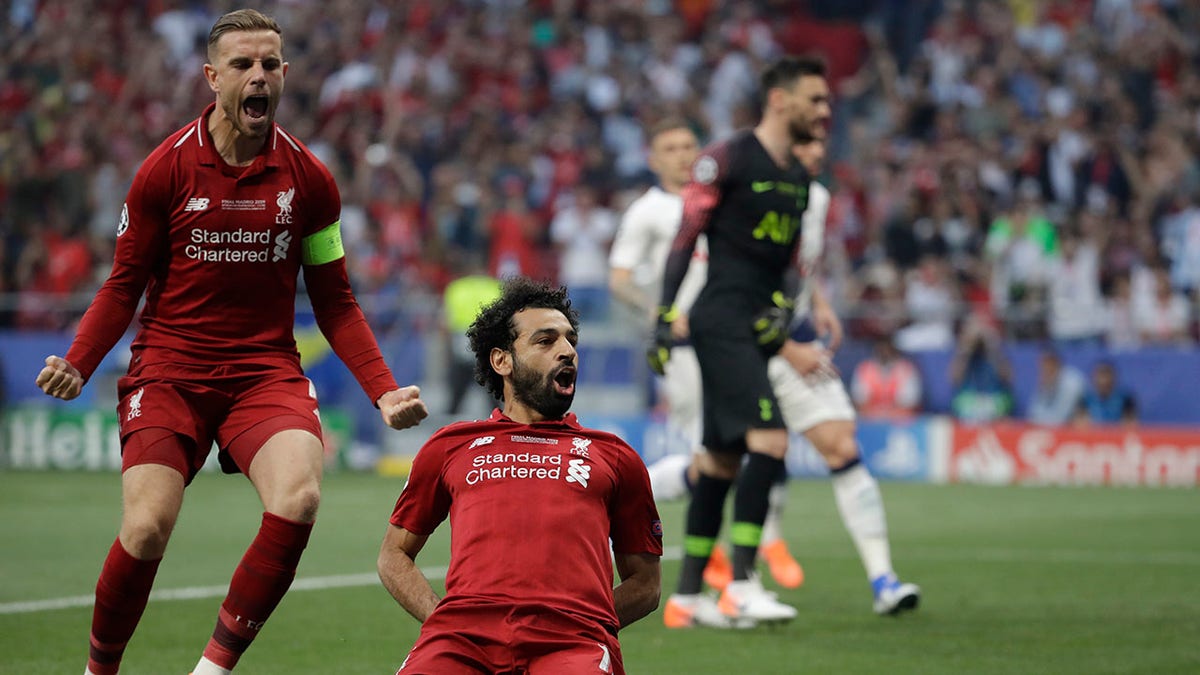 Liverpool's Mohamed Salah, bottom, celebrates after scoring his side's opening goal during the Champions League final soccer match between Tottenham Hotspur and Liverpool at the Wanda Metropolitano Stadium in Madrid, Saturday. (Associated Press)