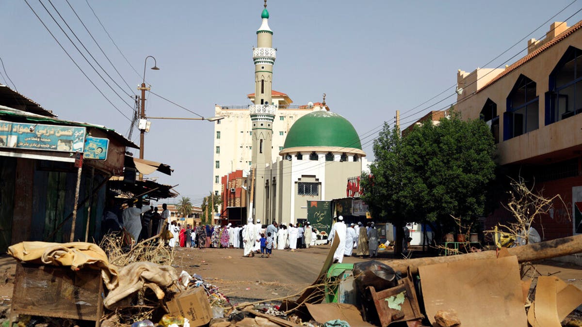 Worshipers gather at a mosque behind a roadblock set by protesters on a main street in the Sudanese capital Khartoum to stop military vehicles from driving through the area on Wednesday, June 5, 2019.