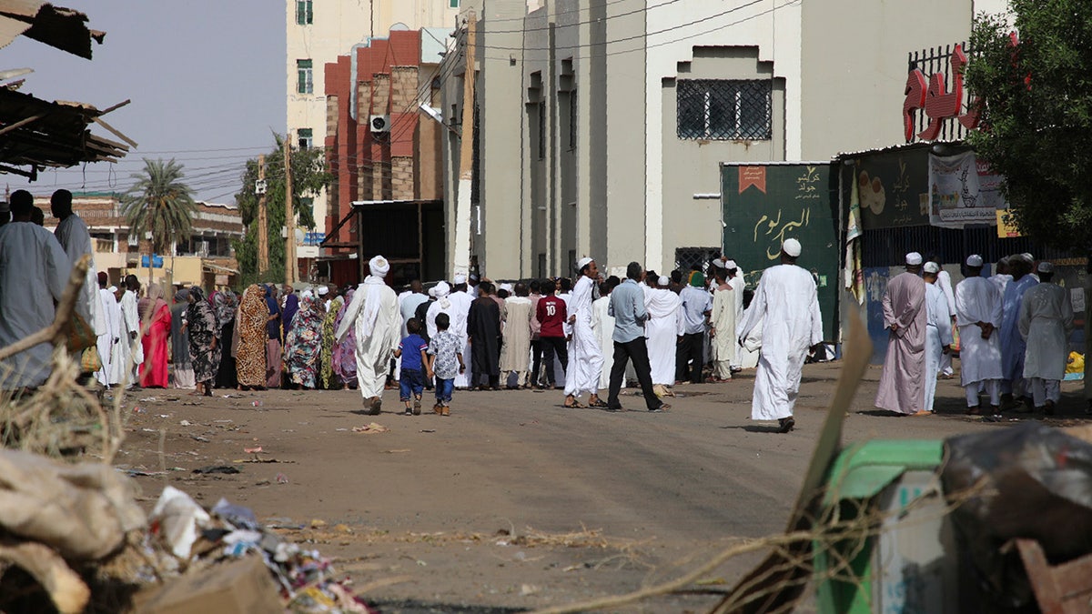 Worshippers gather at a mosque behind a roadblock set by protesters on a main street in the Sudanese capital Khartoum to stop military vehicles from driving through the area on Wednesday, June 5, 2019. (AP Photo)