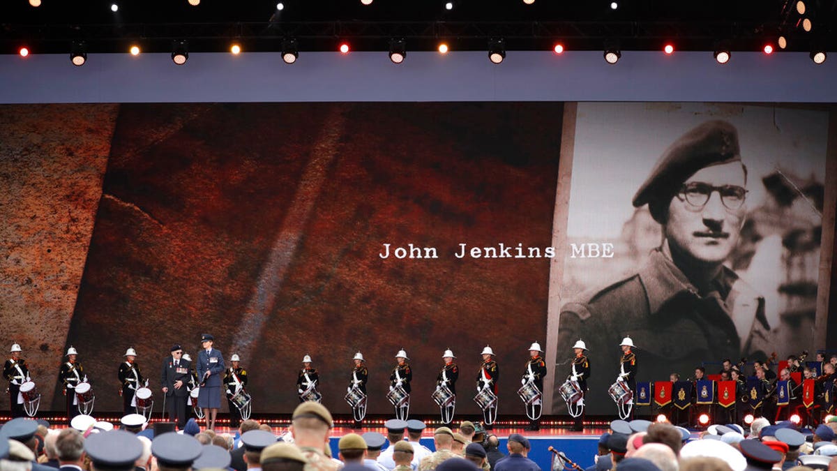 D-Day veteran John Jenkins stands onstage during an event to mark the 75th anniversary of D-Day in Portsmouth, England Wednesday, June 5, 2019.