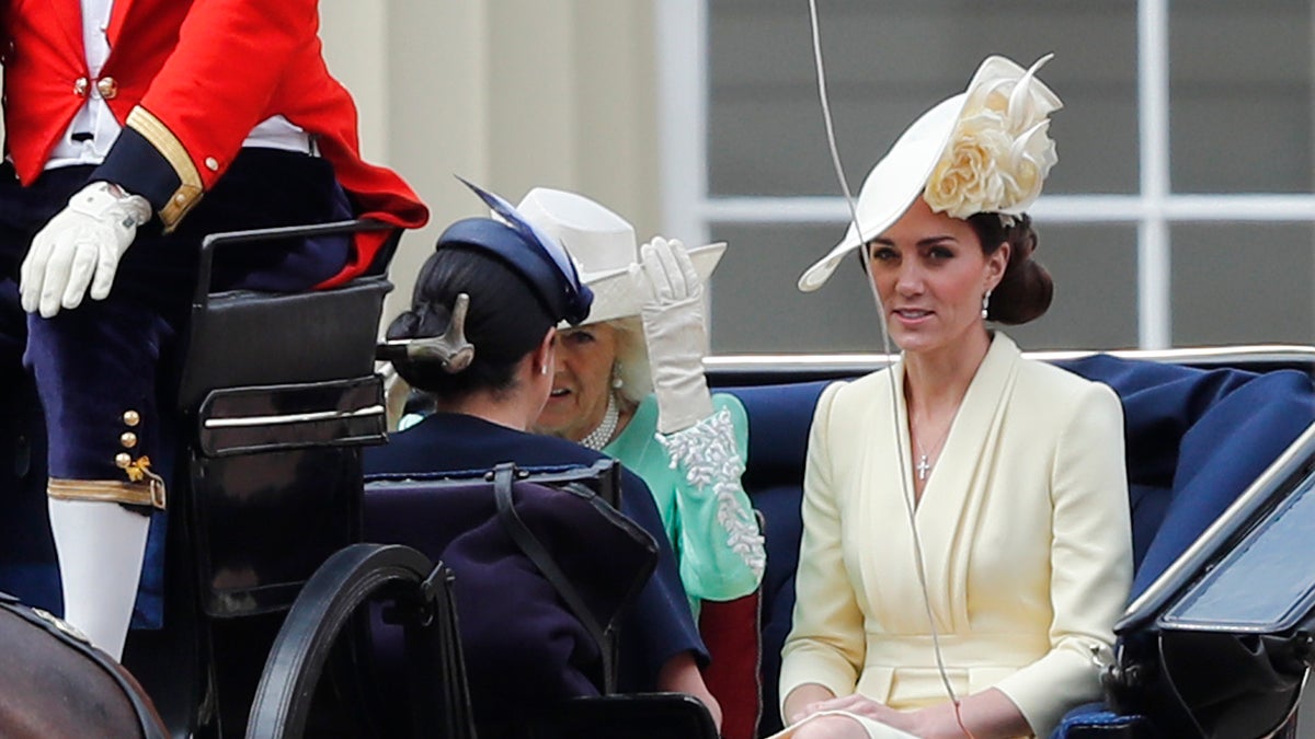 Britain's Camilla, the Duchess of Cornwall, left, Kate, the Duchess of Cambridge and Meghan, the Duchess of Sussex ride in a carriage to attend the annual Trooping the Colour Ceremony 