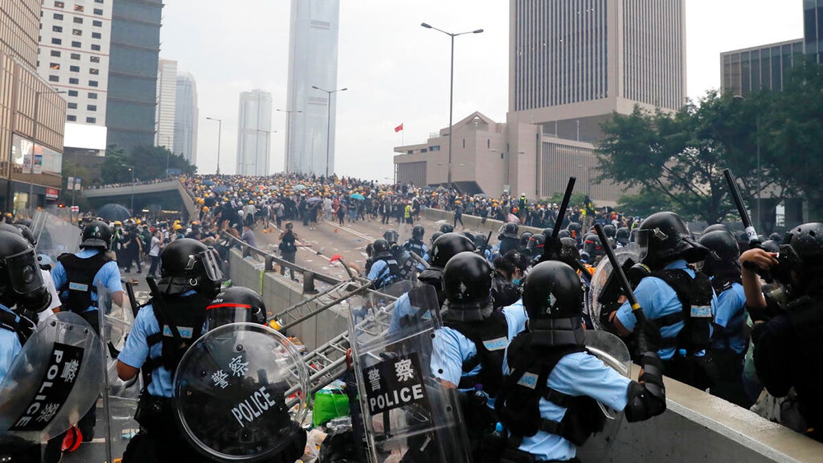 Riot police gather face off with demonstrators near the Legislative Council in Hong Kong, Wednesday, June 12, 2019. 