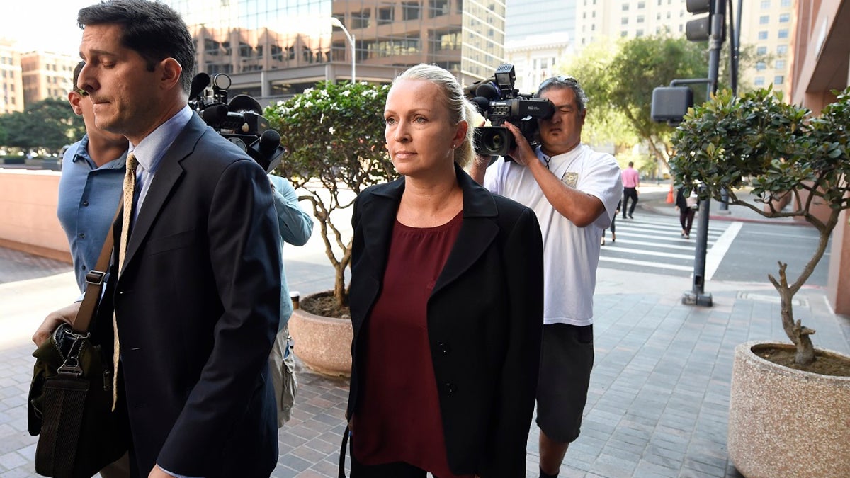 In this Thursday, Aug. 23, 2018, photo, Margaret Hunter, center, the wife of U.S. Rep. Duncan Hunter, arrives for an arraignment hearing in San Diego. (AP Photo/Denis Poroy)