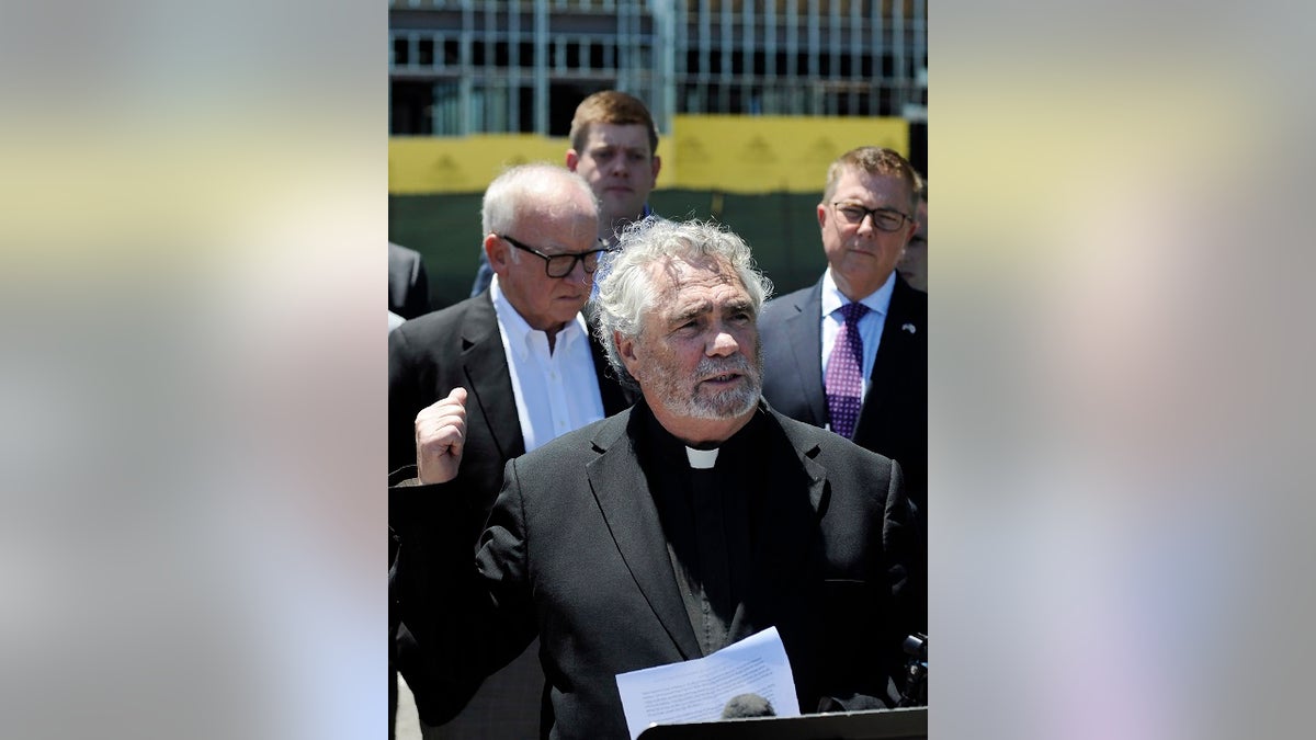 Anti-abortion activist Rev. Terry Gensemer gestures toward a new clinic being constructed by Planned Parenthood in Birmingham, Ala., on Thursday, June 13, 2019. The organization is working on the project despite a new state law that virtually bans abortion in Alabama. (AP Photo/Jay Reeves)