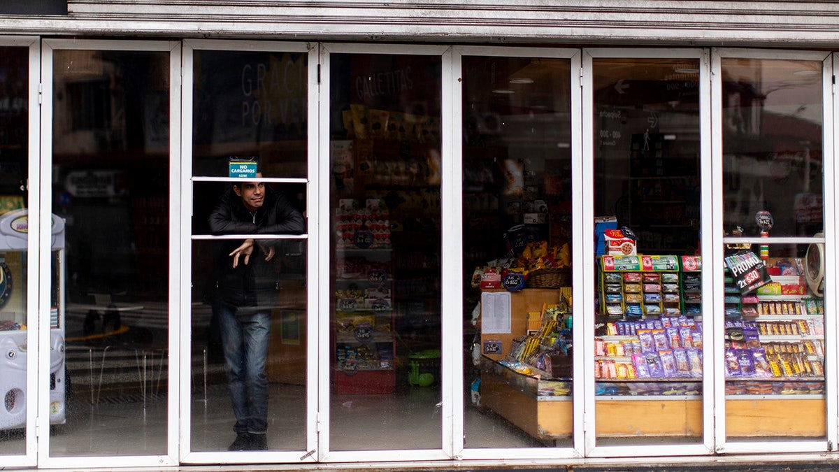 A man stands inside a store without power during a blackout, in Buenos Aires, Argentina, Sunday, June 16, 2019. Argentina and Uruguay were working frantically to return power on Sunday, after a massive power failure left large swaths of the South American countries in the dark. (AP Photo/Tomas F. Cuesta)