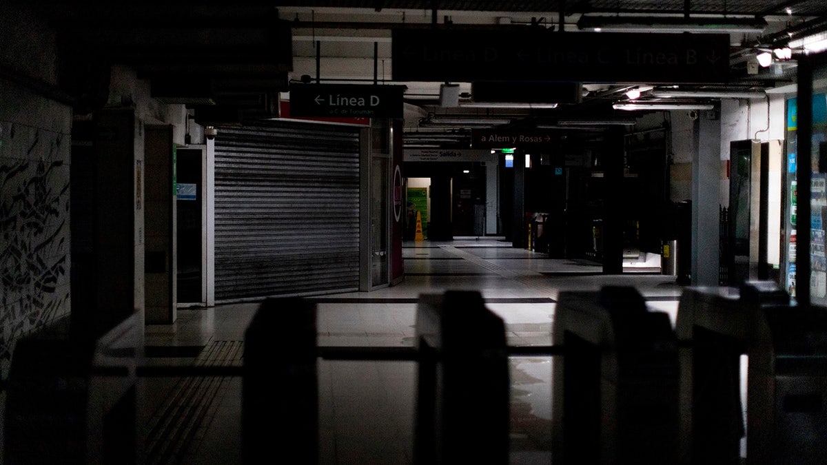 Hallways of Buenos Aires's subway are lit only by emergency lights during a blackout, in Buenos Aires, Argentina, Sunday, June 16, 2019. Argentina and Uruguay were working frantically to return power on Sunday, after a massive power failure left large swaths of the South American countries in the dark. (AP Photo/Tomas F. Cuesta)