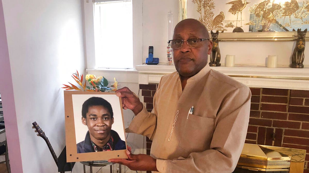 FILE: Dia Khafra, father of Askia Khafra, holds a photo of his son in his Silver Springs, Md., home. 