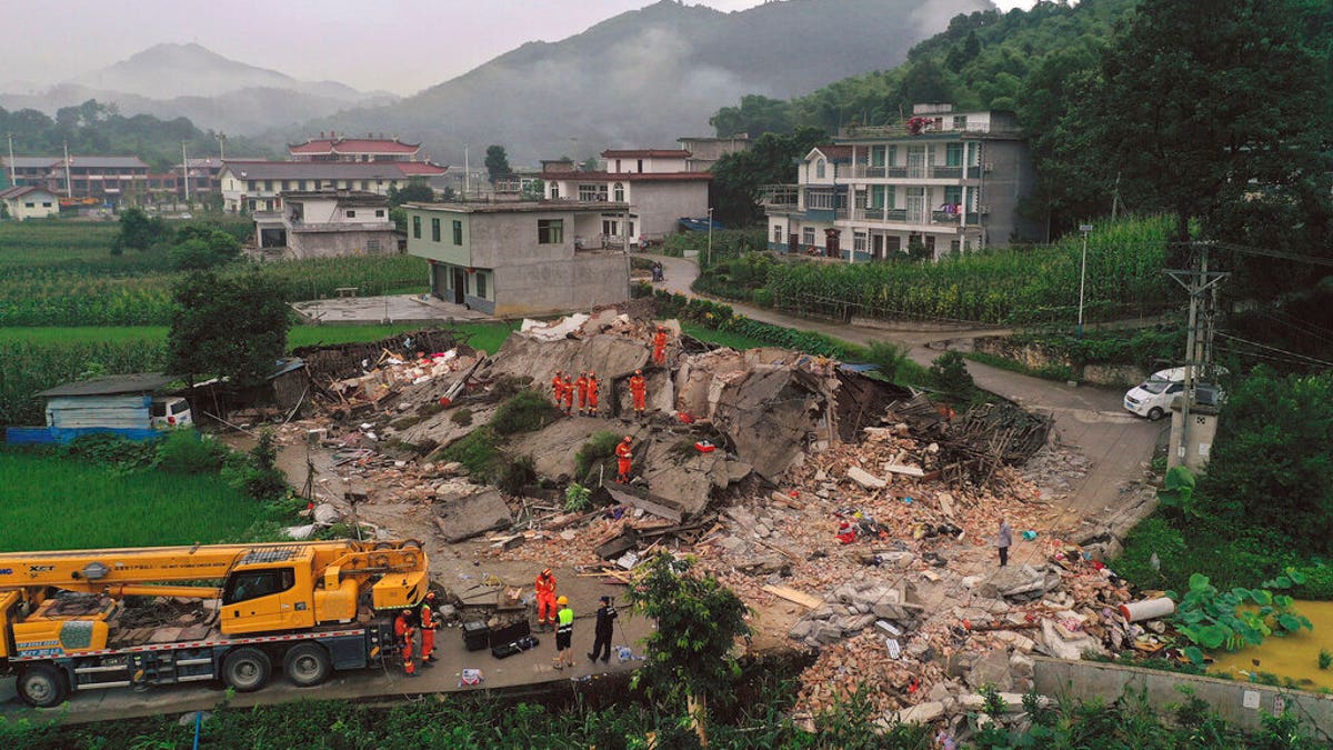 Rescue workers search for trapped people at a collapsed building after an earthquake in Shuanghe Town in Changning County of Yibin City, southwest China's Sichuan Province on Tuesday.