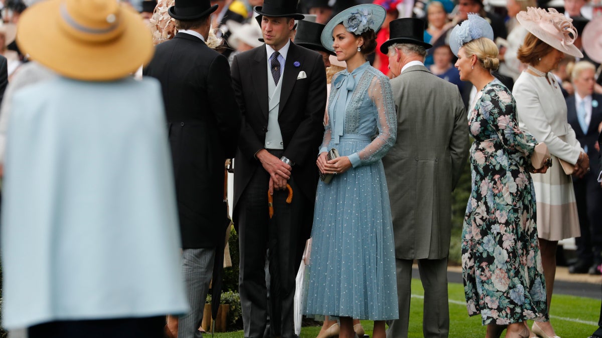 Britain's Prince William, center, and Kate, Duchess of Cambridge, arrive on the day one of the annual Royal Ascot horse race meeting in Ascot, England, Tuesday, June 18, 2019. (AP Photo/Alastair Grant)