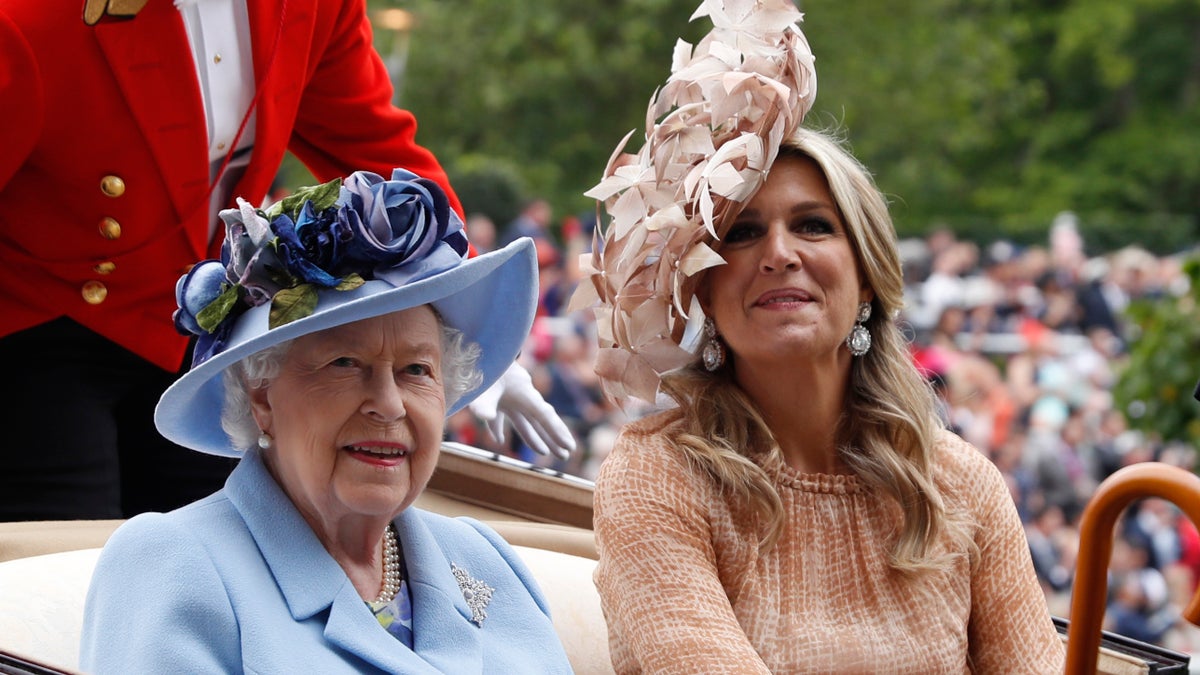 Queen Elizabeth II and Netherlands' Queen Maxima arrive on the day one of the annual Royal Ascot horse race meeting in Ascot, England. (AP Photo/Alastair Grant)
