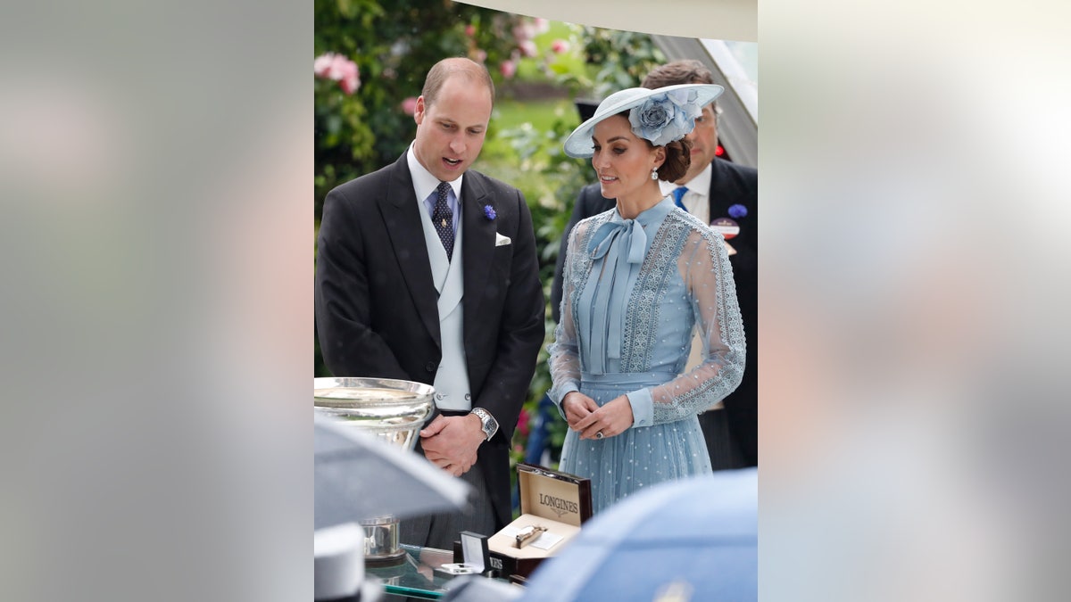 Britain's Prince William and Kate, Duchess of Cambridge, stand next trophies during the day one of the annual Royal Ascot horse race meeting in Ascot, England, Tuesday, June 18, 2019.