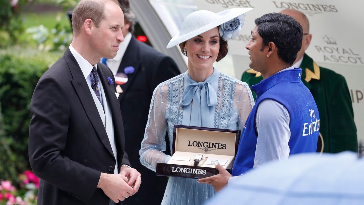 Britain's Prince William and Kate, Duchess of Cambridge, present winners with their trophy's for the Kings Stand stakes race during the day one of the annual Royal Ascot. (AP Photo/Alastair Grant)